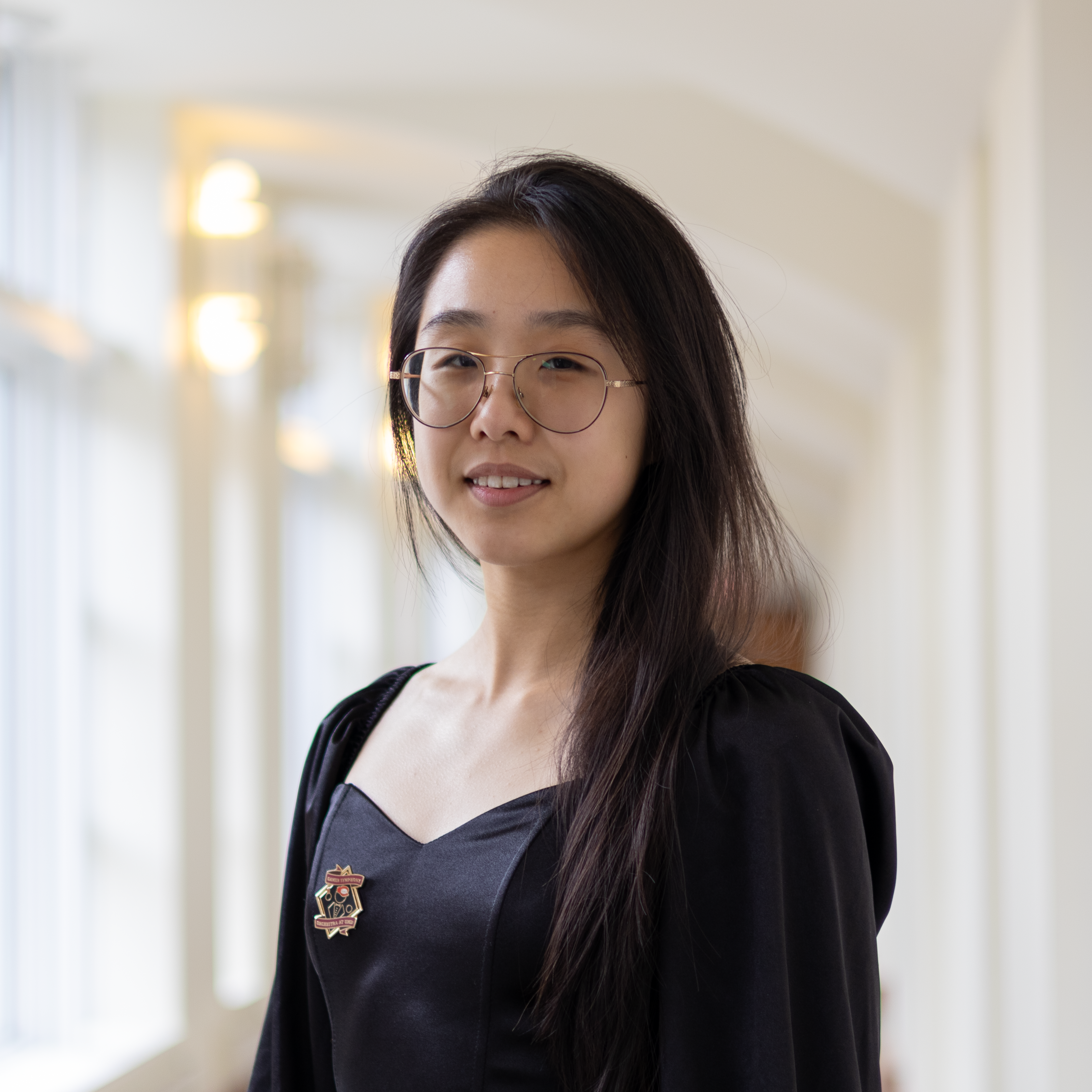 Portrait of Cynthia Xi in dark top and glasses.