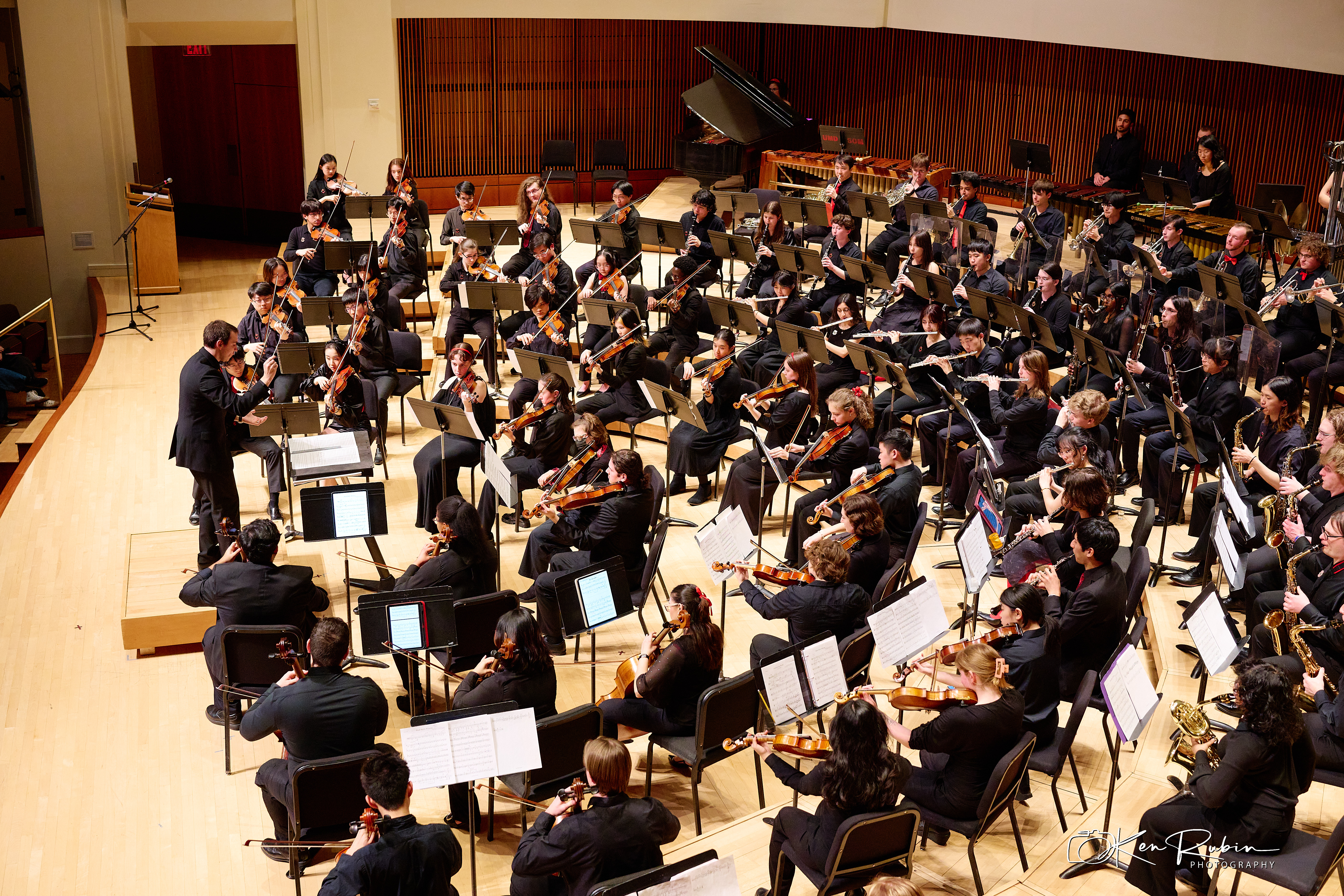 Members of the Gamer Symphony Orchestra seated on stage during a performance.
