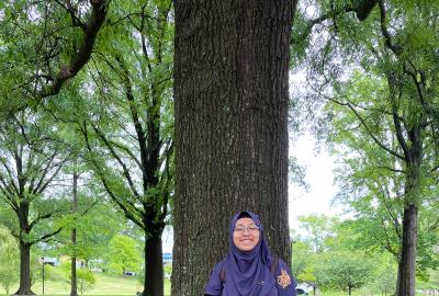 Muntaha Hossain standing in front of a tree
