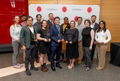 Group photo of awardees in front of a CMNS step-and-repeat banner
