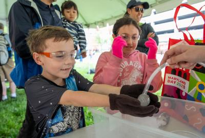 Kids participating in an experiment at Maryland Day 2025