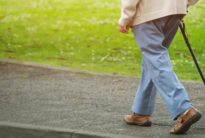 Person walking with cane 